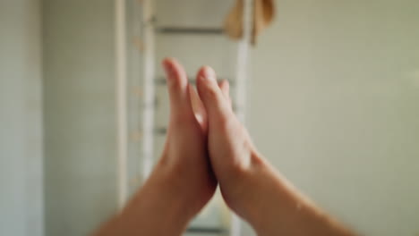 pov of athlete gripping gymnastic ring for workout, hand stretching before exercise, indoor gym setting