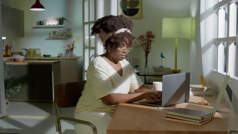 african american woman working on laptop at home