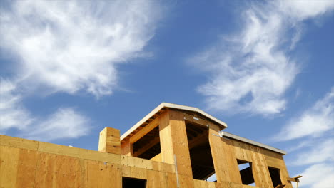 Timelapse-of-clouds-blowing-above-a-house-under-construction