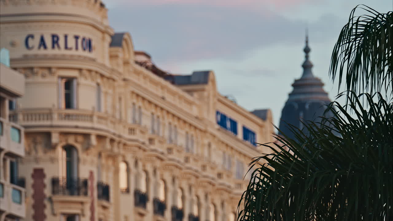 View of the Carlton Hotel on the coast in the evening in Cannes, France
