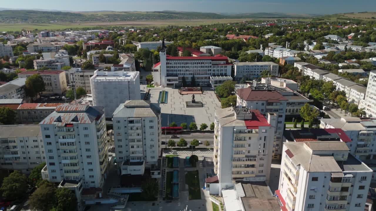 Aerial view of vibrant urban area with tall buildings and green landscapes
