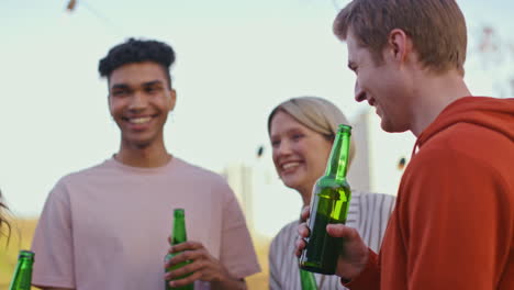 boozy mates playing game at rooftop close up. millennials gathering together