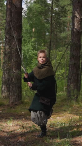 little warrior boy runs with sword to attack through forest historical reconstruction childrens camp