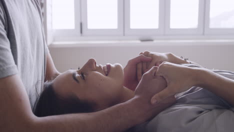 young affectionate couple kissing at home