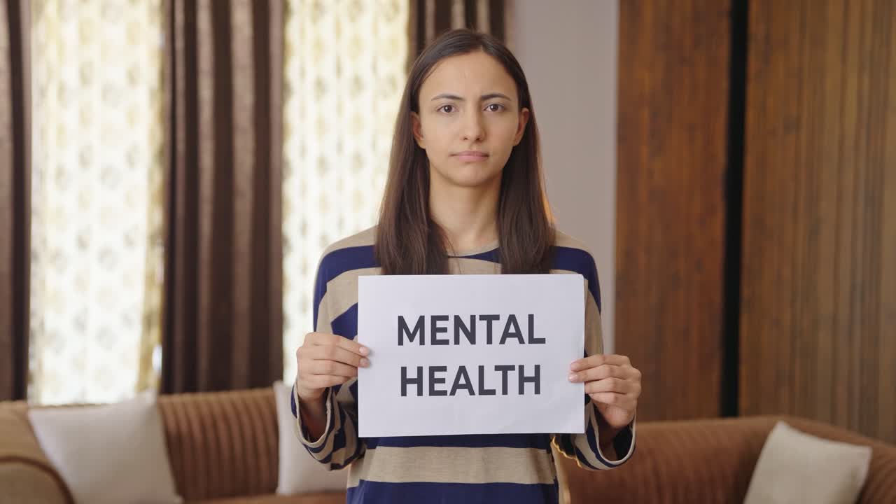 Mujer india triste sosteniendo pancarta de SALUD MENTAL