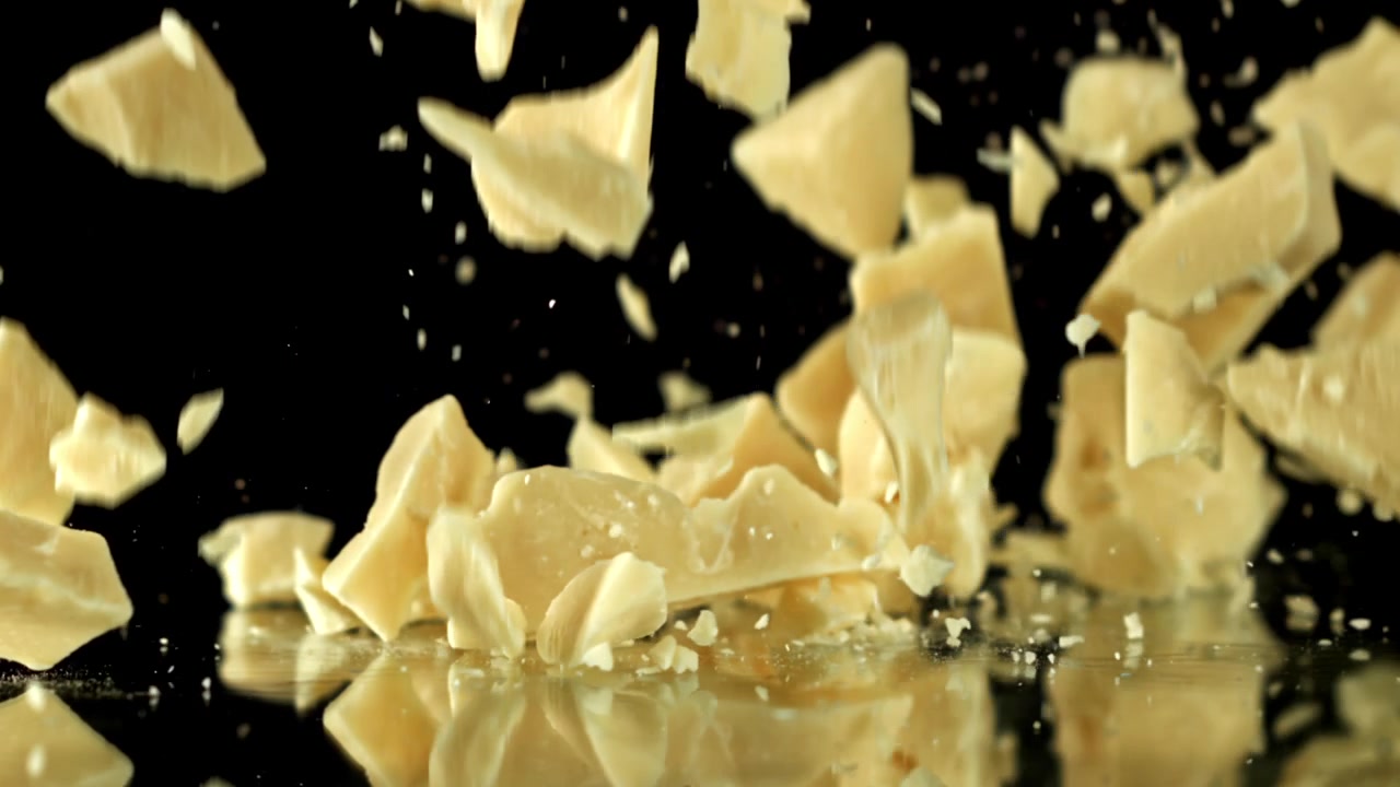 White Chocolate Chunks Falling and Piling Up in Slow Motion