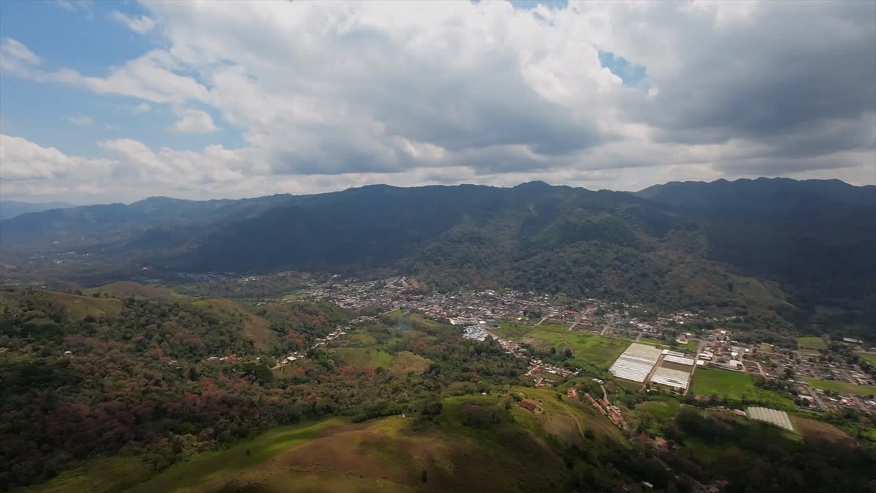 Drone view of Caripe town with houses, farms, and mountains in Venezuela