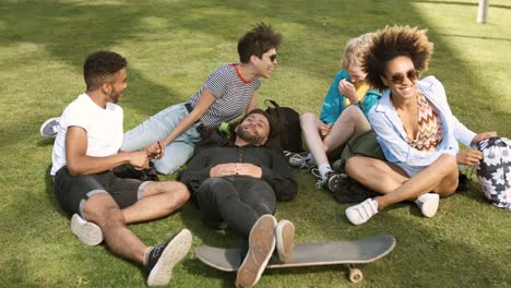 Lounging-friends-on-meadow-in-park-