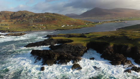 Cinematic-tilting-upward-drone-shot-of-the-ocean-waves-hitting-rocky-coast-at-the-White-Cliffs-of-Ashleam,-Ireland