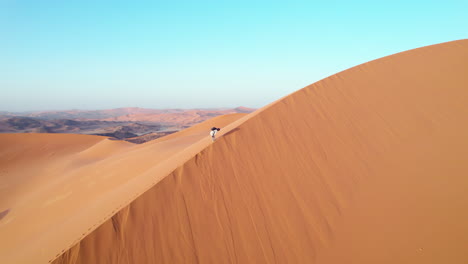 hiker on the sand dunes of djanet desert in algeria