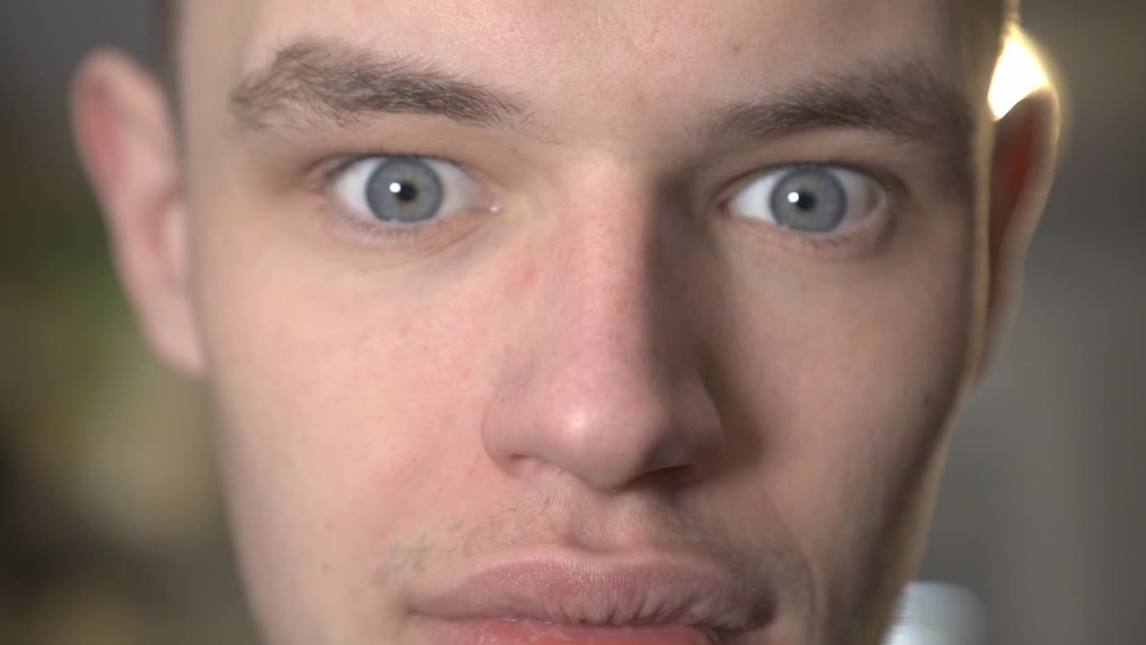 A Handsome Guy's Face With Serious Expression And Eyes Wide Open - Closeup Shot