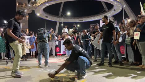 it employees drawing graffiti on street protesting with placard against the rape and murder of a postgraduate trainee doctor at kolkata's rg kar hospital.