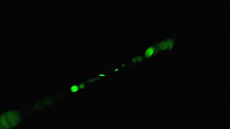rayo láser verde sobre un fondo negro. rayo láser de potencia que brilla en la niebla