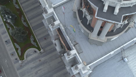 damaged government building in the city with flags