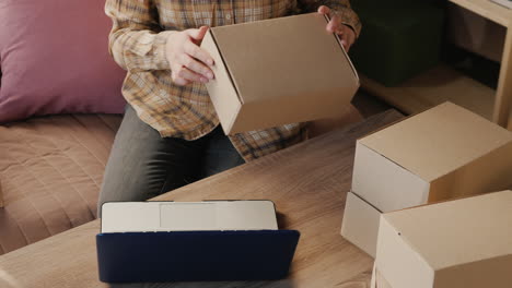 view from above as a woman sorts parcels ready to ship