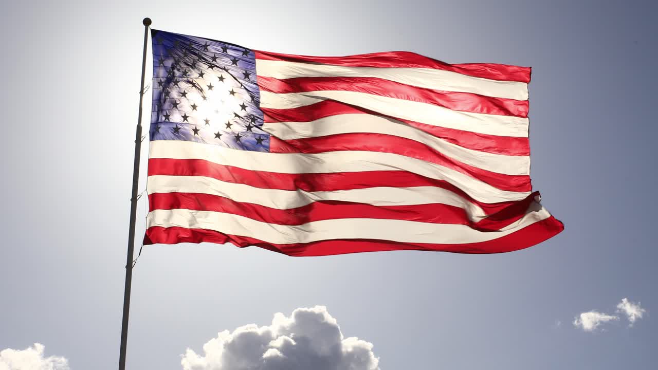 The American flag, emblematic of national unity and pride, waves proudly in the sunlight on Labor Day, Independence Day, and other patriotic occasions.