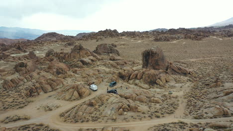 Camping-in-Alabama-Hills,-California-USA,-Drone-Aerial-View,-Vans-in-Dry-Desert-Landscape,-Drone-Shot