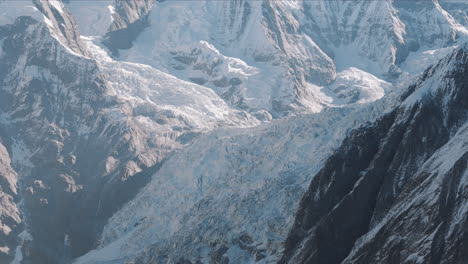 The-landscape-of-Mount-Everest,-the-world's-highest-peak-in-Nepal,-glacier-melting,-snow,-sunny-environment,-global-warming,-drone-shot-showing-features-of-mountain-rock-4K