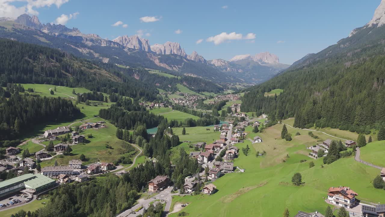 Amazing aerial orbit over picturesque alpine valley of Val di Fassa, Moena, Dolomites, Trentino, Italy