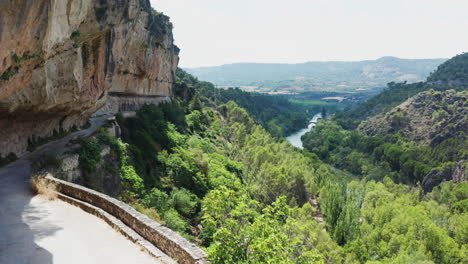 Still-aerial-shot-of-Mirador-el-Puente-Romano-road-and-plateau-mountain