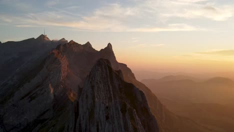 Flying-around-Schafler-Ridge-in-Appenzell,-Switzerland-during-sunset-in-summer