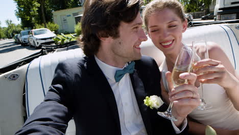 Just-married-couple-in-a-blue-convertible-car