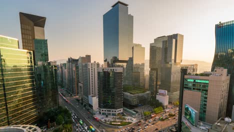 timelapse of light trails traffic speeds through an intersection in gangnam center business district of seoul at seoul city, south korea.