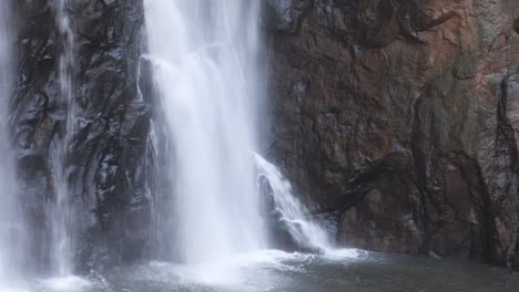 water flowing down a rocky cliff face