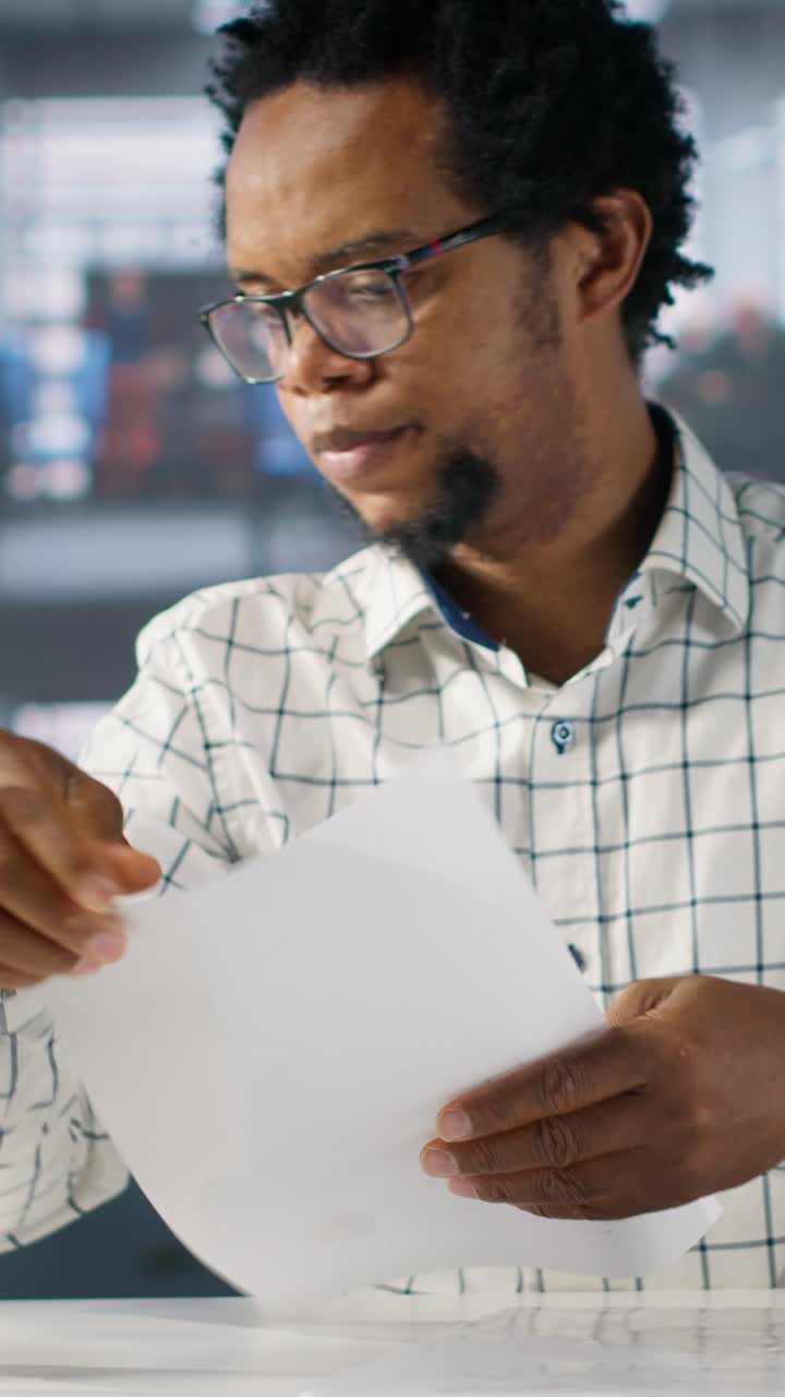 African American Businessman Reviewing Documents in Office