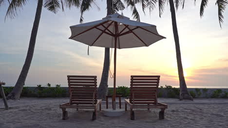 Two-Sunbeds-and-Parasol-at-Sunset-Luxury-Tropical