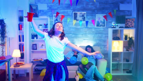 Care-free-young-woman-dancing-with-a-cup-of-beer