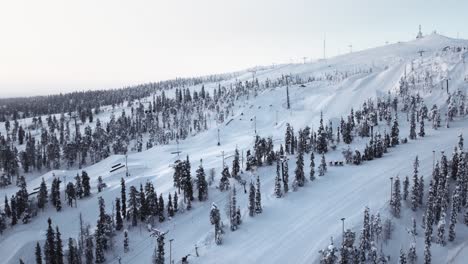 aerial view empty downhill ski slope at resort in lapland in finland