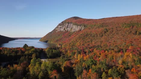 Beautiful-aerial-drone-footage-of-the-fall-leaves-on-and-around-Mount-Hor,-Mount-Pisgah,-and-Lake-Willoughby-during-peak-autumn-foliage-at-Willoughby-State-forest-in-Westmore,-Vermont