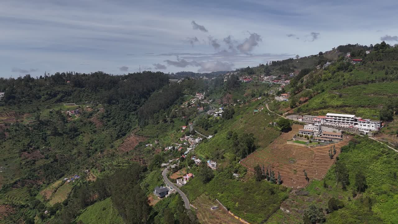 Drone orbit around a peaceful hill resort nestled among dense foliage