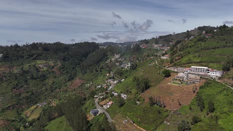 drone orbit around a peaceful hill resort nestled among dense foliage