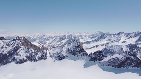 beautiful cinematic aerial of snowy alpine mountain glacier peaks