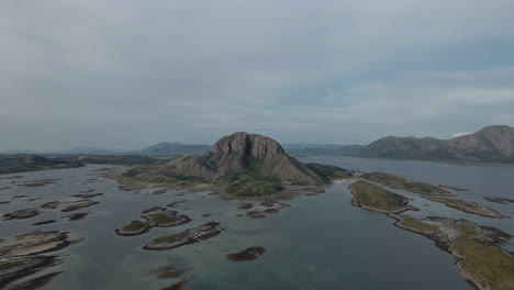 Torghatten-Mountain-On-Torget-Island-Outside-Of-Brønnøysund-On-The-West-Coast-of-Norway,-Helgeland-Coast---aerial-pullback