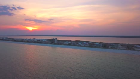 A-dramatic-aereal-orbit-of-a-small-beach-town-in-Florida-at-sunset