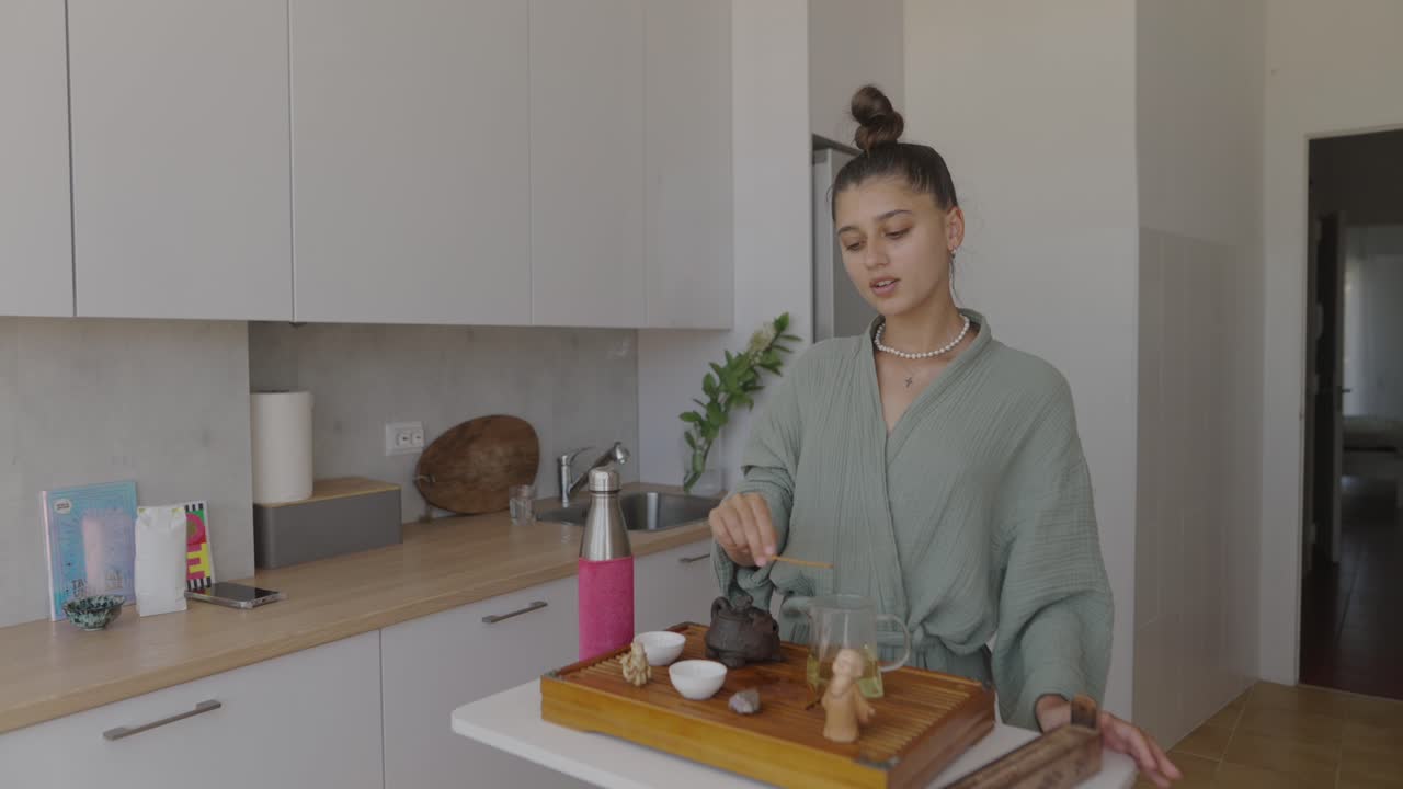 Woman Performing Tea Ceremony in Kitchen