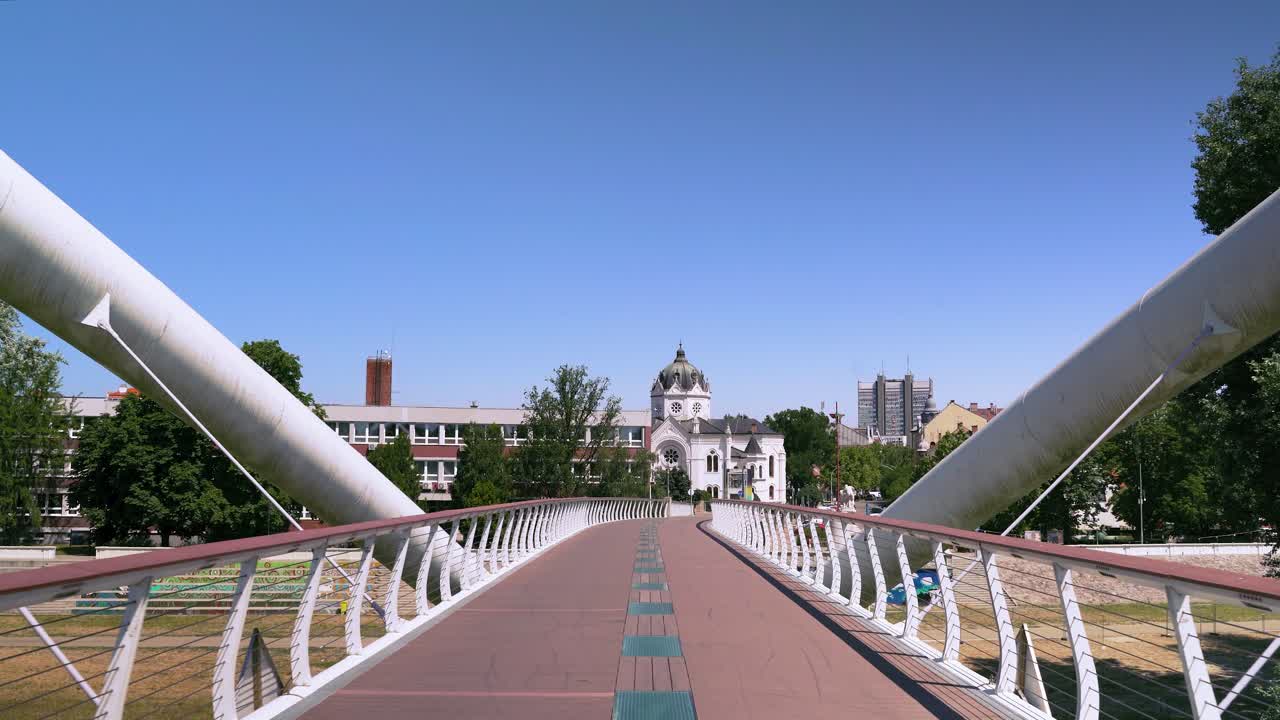 Walking on the Tiszavirag Footbridge in Szolnok city, Hungary