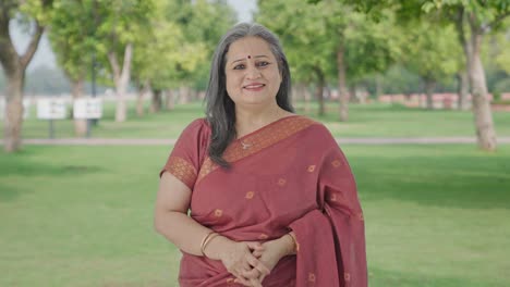 Happy-Indian-old-woman-smiling-to-the-camera-in-park