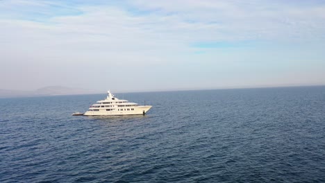 aerial over a large white private yacht cruising off the coast of santa barbara california