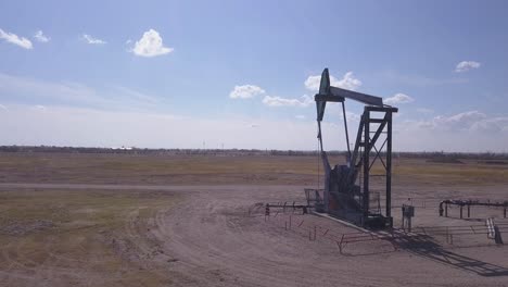 Pumpjack-nods-quietly,-pumping-oil-from-under-Alberta-prairie-soil