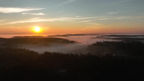 drone shot of mountainous peaks surrounded by dense fog on washington's whidbey island