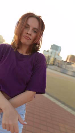 young woman with headphones in the city