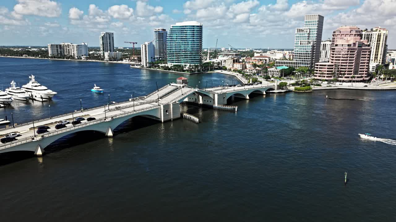 Push in drone shot of Royal Park Bridge opening, One Flagler and Phillips Point building during the day in West Palm Beach, Florida, USA