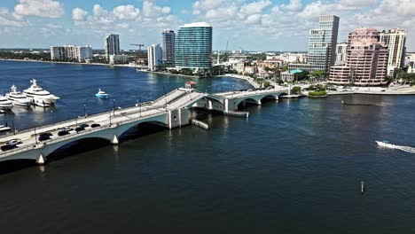 push in drone shot of royal park bridge opening, one flagler and phillips point building during the day in west palm beach, florida, usa