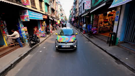 colorful car in a busy asian city street