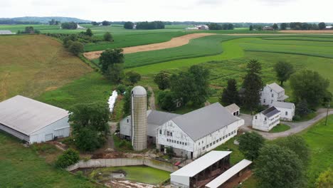 Orbit-of-farm-with-rundown-buildings,-waste-water-runoff