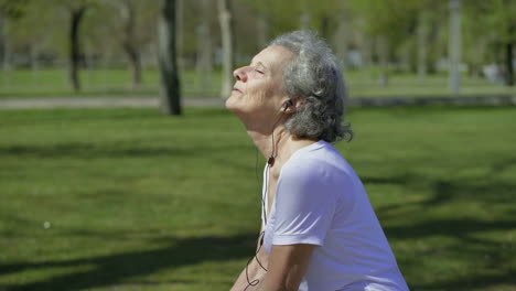 smiling senior woman enjoying of sunny summer day.